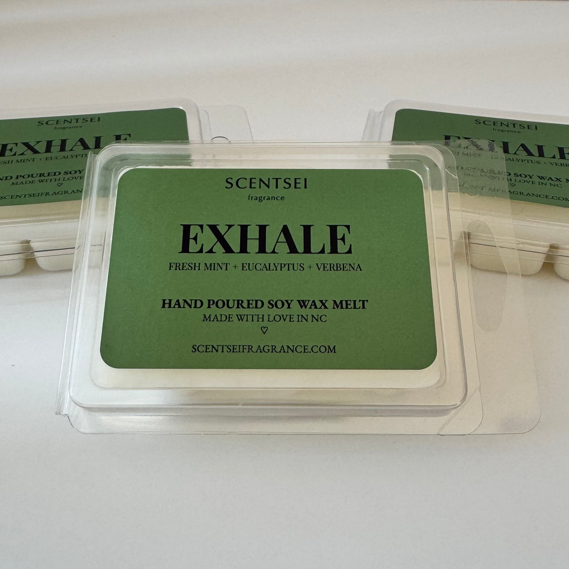 Three Scentsei Fragrance wax melts labeled 'EXHALE' on a white background